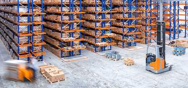 Warehouse with racking and forklifts