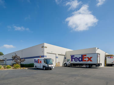 Media Coverage - FedEx trucks at warehouse