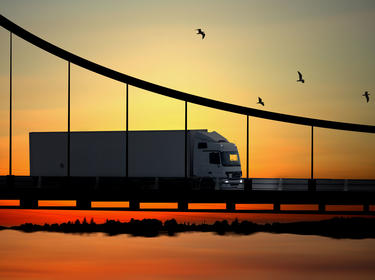 Truck on a bridge at sunset